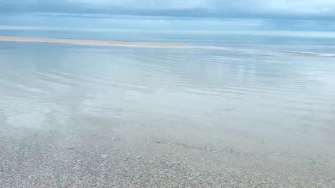 Quiet sea close up with a sandy beach with small waves Stock Footage 128701215
