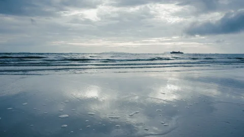 Quiet Seaside At Twilight Showcasing Sparkling Surface And Distant Boat Stock Footage 327724475
