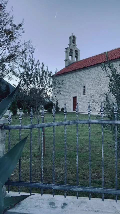 Quiet stone chapel at sunset, ancient stone religious site with overgrown Stock Footage 320324637