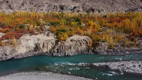 A quiet stream bordered by vivid autumn tones in a mountain landscape. Stock Footage 310782886