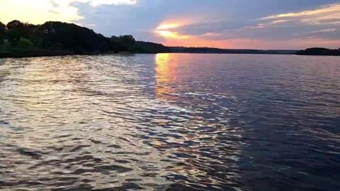 Quiet sunset on the lake with reflection in the water and forest shore. Stock Footage 313009903