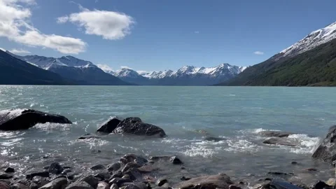 Quiet surf against the backdrop of snow-capped mountains Stock Footage 220582896