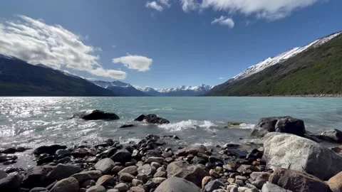 Quiet surf against the backdrop of snow-capped mountains Stock Footage 220582901