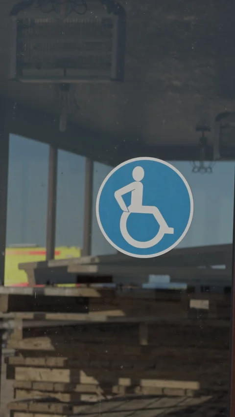Quiet train platform featuring wheelchair symbol and subdued lighting. Serene Stock Footage 333984258