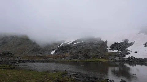 Quiet tranquil mountain lake. Reflection of green peaks in water Stock Footage 93953692