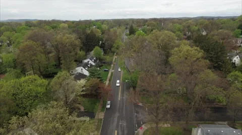 Quiet Two Lane Street Under Trees Coming Into Leaf Stock-Footage 62523928