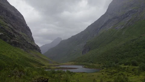 Quiet U Shaped Mountain Gorge with Small Lake in Norwegian Nature Fjord Stock Footage 342081001