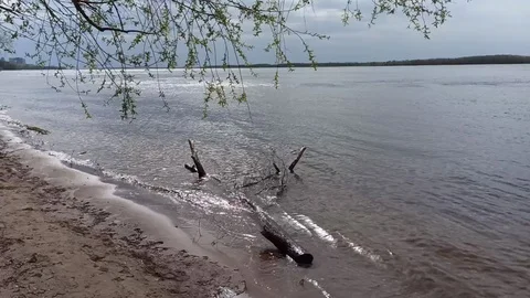Quiet Volga river, smooth lapping waves. Rare rays of the sun on the river Stock Footage 129908356