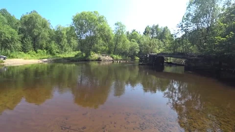 Quiet whirlpool on a mountain river, an old ruined bridge on a river Stock Footage 146729725