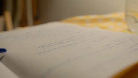 Quiet workspace featuring handwritten notes and glowing lamp ambiance Stock Footage 324591653