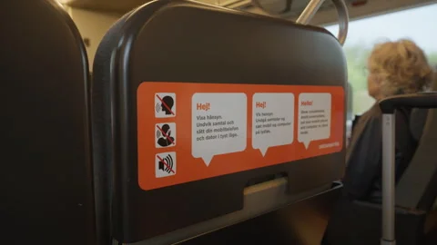 Quiet zone sticker on a passenger train seat instructs travelers to stay silent Stock Footage 344956417