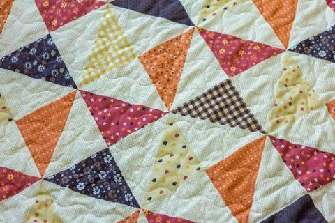 Quilt. A fragment of a patchwork quilt as a background. Colored patchwork qui Stock Photos