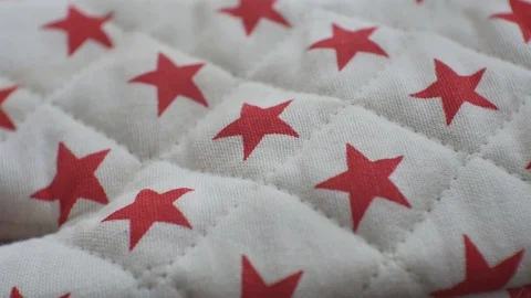 Quilt textile with red star pattern, close up on intricate craftsmanship Stock Footage 109408397