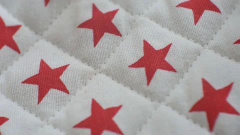 Quilt textile with red star pattern, close up on intricate craftsmanship Stock Footage 109408419