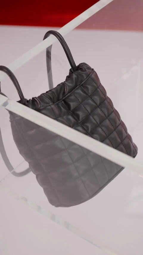 Quilted Black Ecological Leather Backpack on Clear Acrylic Display Stand Video stock 307169946
