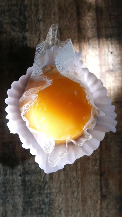 A Quindim on a table (a pudding made of sugar, coconut, and egg yolks) Stock Footage 314344127