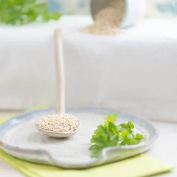 Quinoa in a ceramic spoon Stock Photos