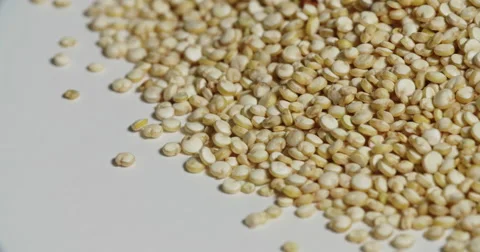 Quinoa Pile Close Up Edge on White Spins Stock Footage 64974313