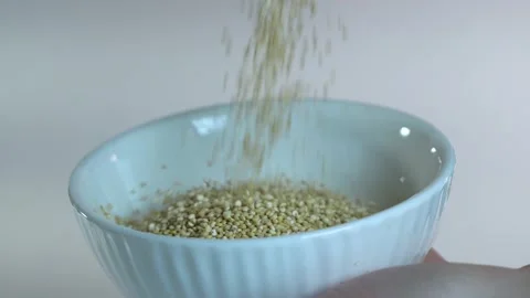 Quinoa is poured into a white plate. Stock Footage 295212589