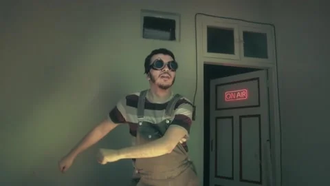 Quirky Guy in Goggles Dancing Live with Neon On Air Sign Stock Footage 340401327