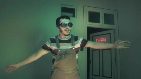 Quirky Retro Man in Goggles Dancing by Neon On Air Sign Stock Footage 340402023