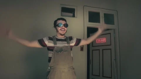 Quirky Retro Man in Goggles Dancing by Neon On Air Sign Stock Footage 340402860