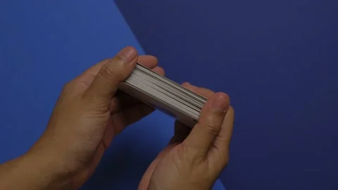 Quirky stop motion animation of hands playing with a deck of cards Stock Footage 201330649