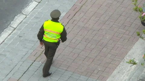 A Quito Beat Cop walks down the Street in Quito, Ecuador Video stock 60427960