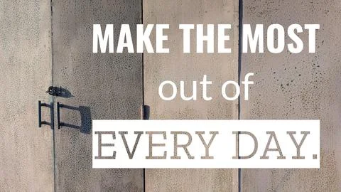 A quote, "Make the most out of every day," is displayed on a textured, gray.. Stock Photos