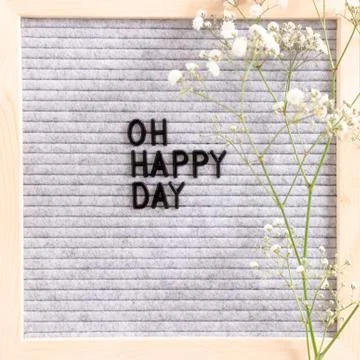 Quote Oh happy day. Composition with letter.board and white flowers Stock Photos