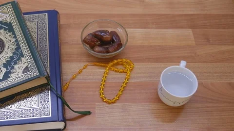 Quran with beads and dates with water. Ramadan is the month of fasting. Stock Footage 75392074