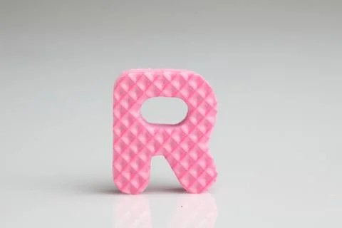 R in pink colour foam Stock Photos