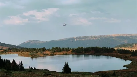 A r44 Helicopter Circles Above A Pristine Mountain Lake Stock Footage 307118366