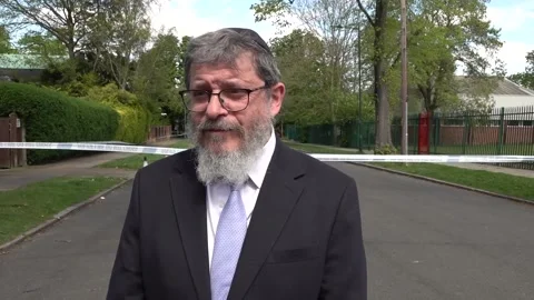 Rabbi speaks at the scene of another attempted arson attack at London synagogue Stock Footage 333046752