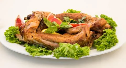 Rabbit baked with grapefruits Stock Photos