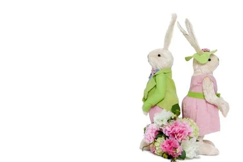 Rabbit couple standing back to back with flower bouquet over white background Fotos Stock