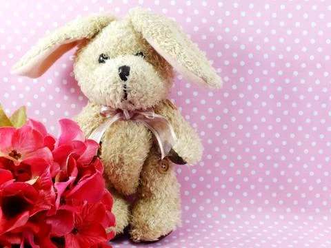 Rabbit doll with space copy on pink polka dot background Stock Photos