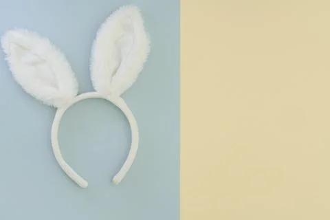Rabbit ears on a two-tone background with place for text. Easter bunny symbol of Fotos Stock