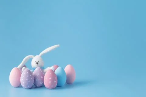 Rabbit with Easter eggs on blue Stock Photos