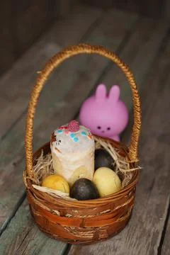 Rabbit with Easter eggs on wooden background. Selective focus. Stock Photos