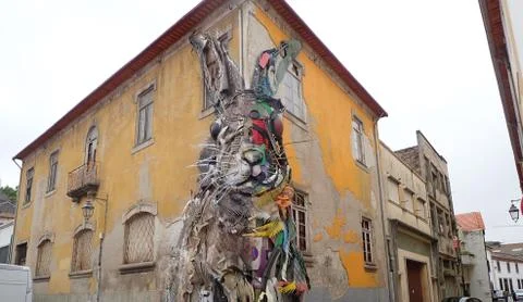 Rabbit or bunny on side of worn building Stock Photos