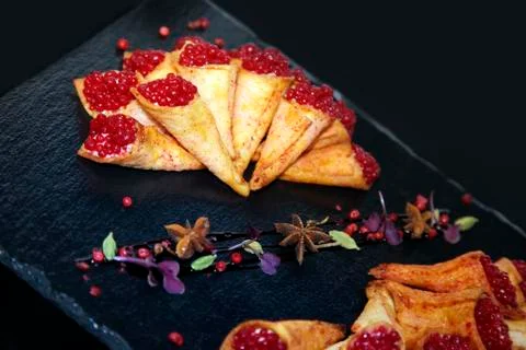 Rabbit pate in crispy horns decorated with spices on a black stone plate Stock Photos