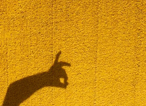 Rabbit shadow on yellow wall, copy space Stock Photos
