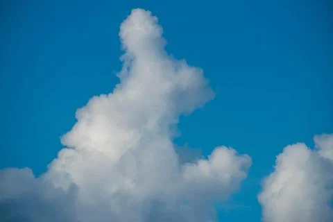 Rabbit shaped cloud on bluelight sky background. Stock Photos
