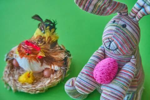 The rabbit takes a colorful Easter egg Stock Photos
