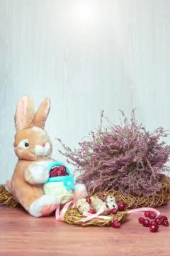 Rabbit toy among Easter eggs and heather bouquet, Stock Photos