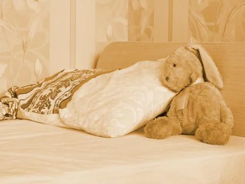 Rabbit toy on the bed Stock Photos