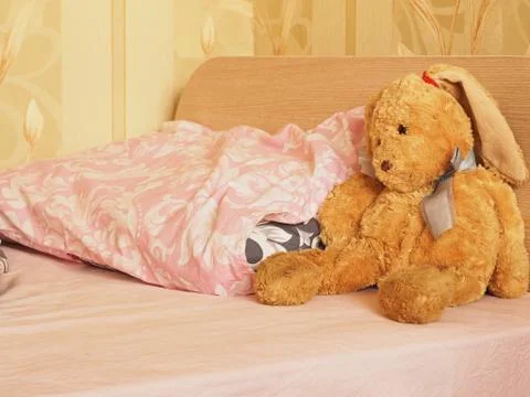 Rabbit toy on the bed Stock Photos