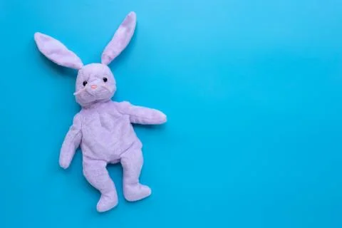 Rabbit toy on blue background. Stock Photos