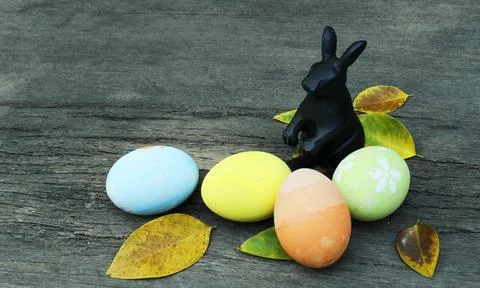 Rabit decoration and fancy easter eggs with atum leaves on wooden backgrounds Stock Photos